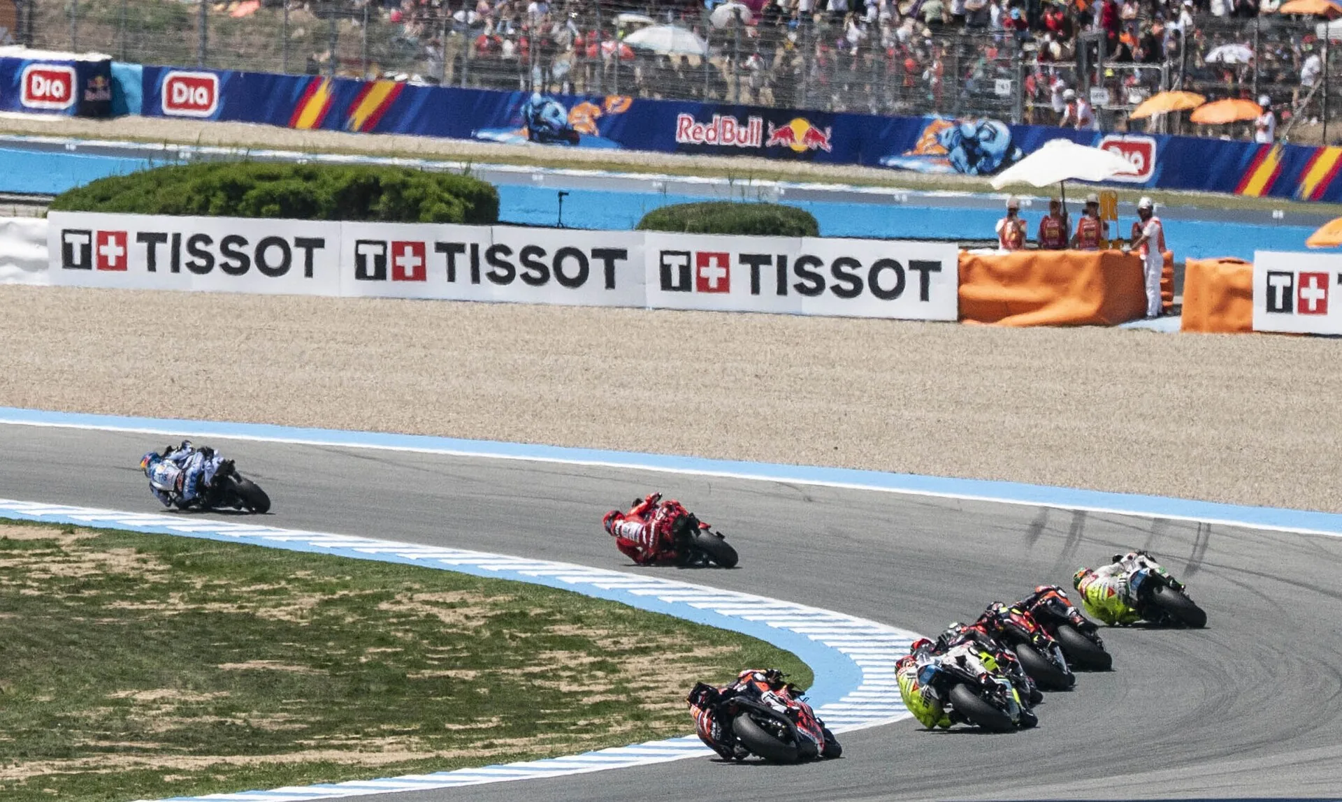 MotoGP riders racing together through a corner