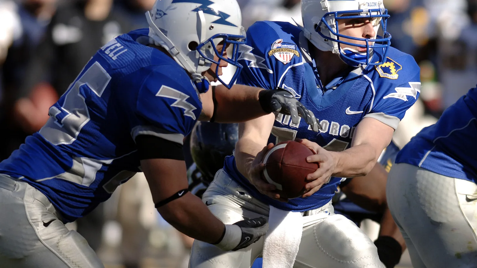 American football quarterback handing off the ball