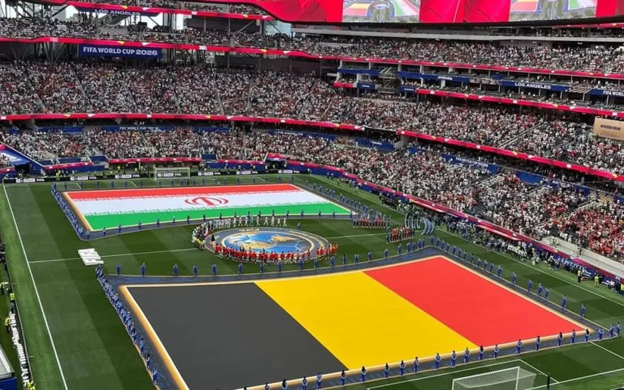 Iran and Belgium flags spread on the pitch at Los Angeles Stadium before their 2026 World Cup group match