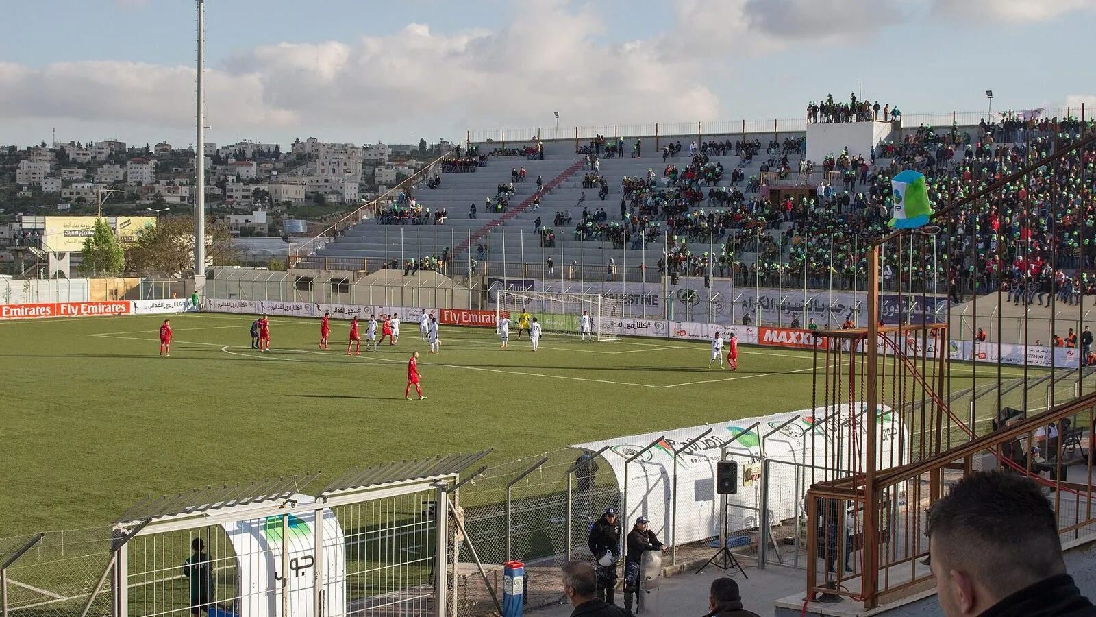 Football match at Dora Stadium with supporters in the stands