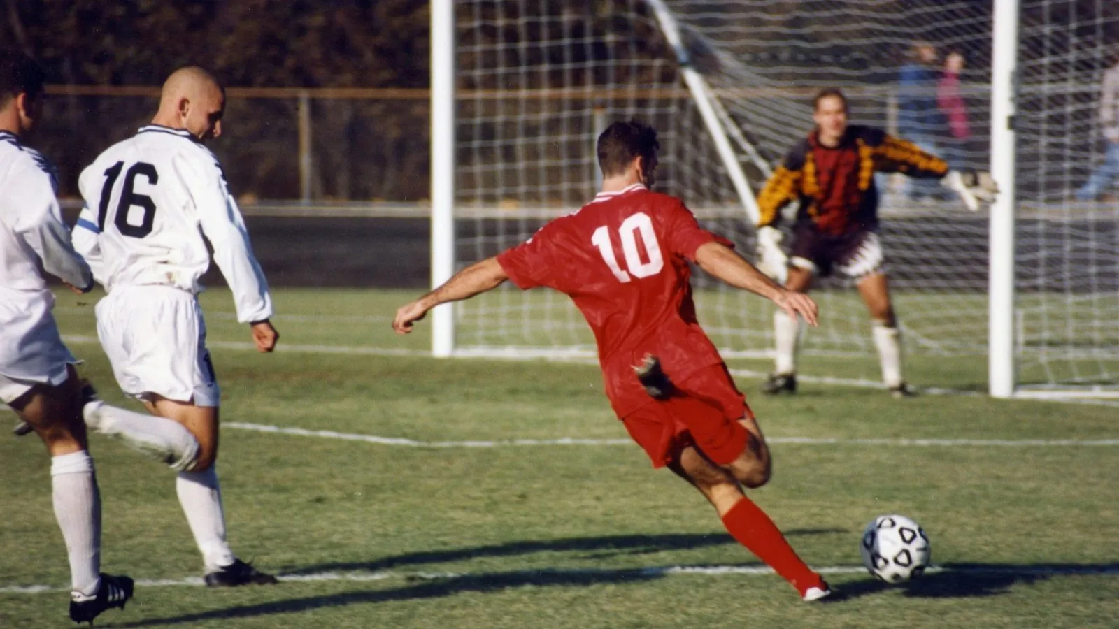 A football player striking a ball on a pitch, illustrating football analysis and handicaps