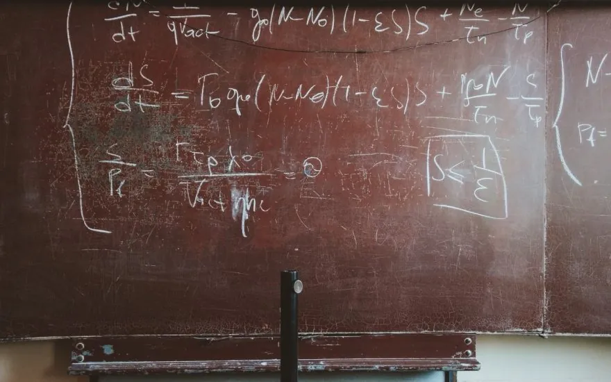 Mathematical formulas written in chalk on a blackboard