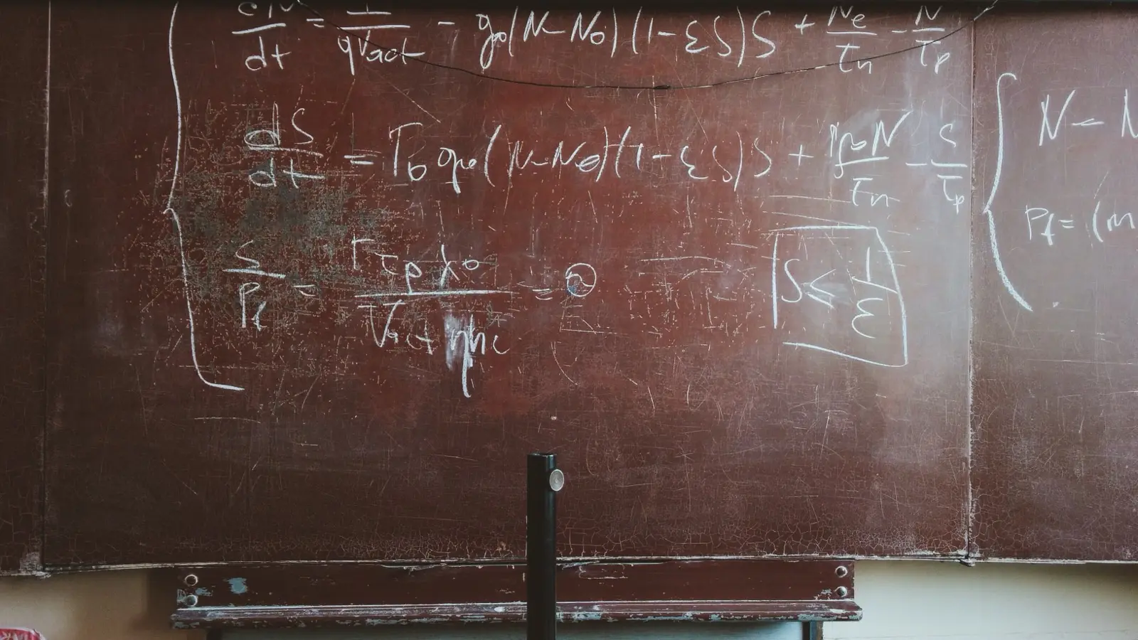 Mathematical formulas written in chalk on a blackboard