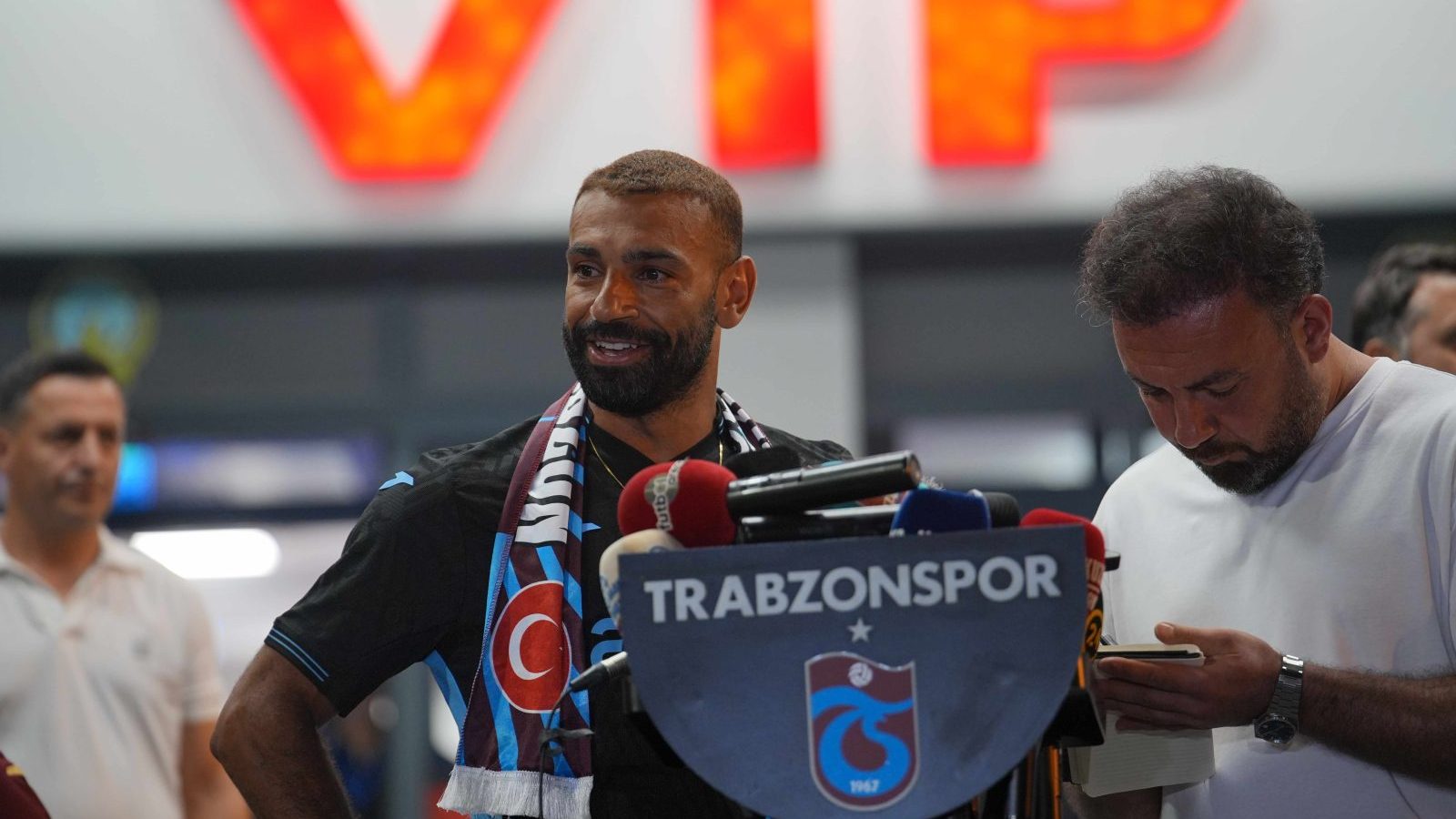 Mohamed Salah in a Trabzonspor shirt surrounded by supporters at Trabzon Airport after the club confirmed his signing