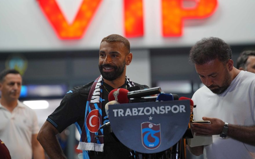Mohamed Salah in a Trabzonspor shirt surrounded by supporters at Trabzon Airport after the club confirmed his signing